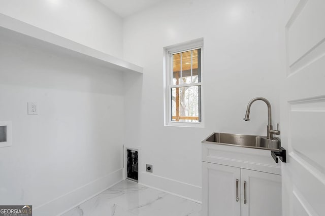 washroom featuring baseboards, washer hookup, cabinet space, electric dryer hookup, and a sink