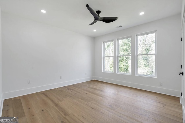 spare room with visible vents, baseboards, and light wood-style floors