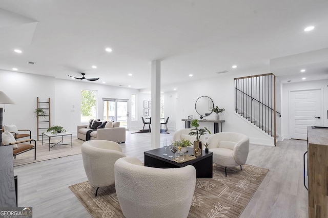 living room featuring a ceiling fan, recessed lighting, stairway, light wood finished floors, and baseboards