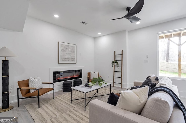 living area with recessed lighting, visible vents, and plenty of natural light