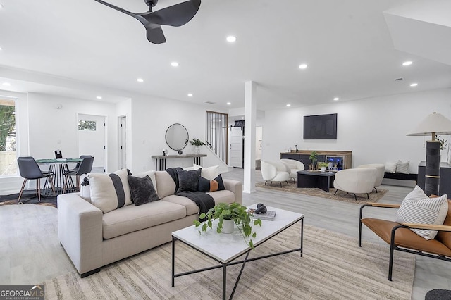 living area with a fireplace, recessed lighting, a ceiling fan, and light wood finished floors