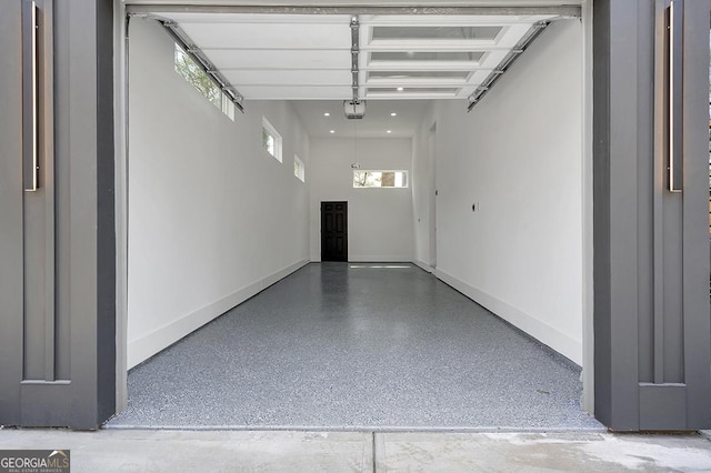 garage featuring a garage door opener and baseboards