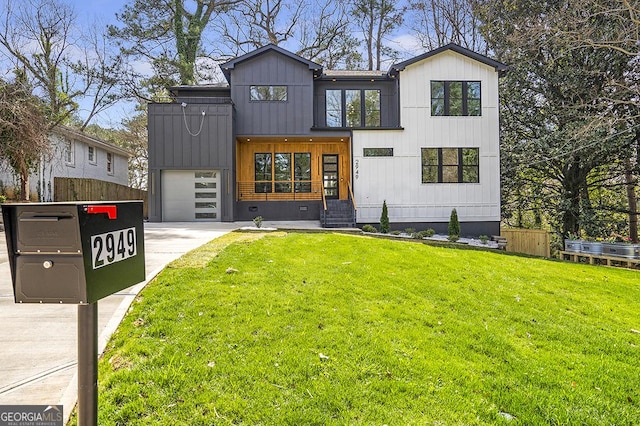 view of front of home with a garage, concrete driveway, and a front lawn