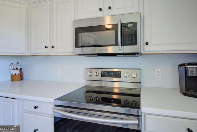 160 Chanticleer Rd, Commerce, GA 30529 - kitchen featuring light countertops, white cabinets, and stainless steel appliances