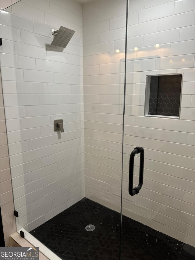 full bath featuring a shower stall