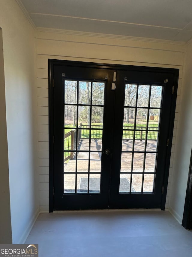 entryway featuring french doors, baseboards, and crown molding