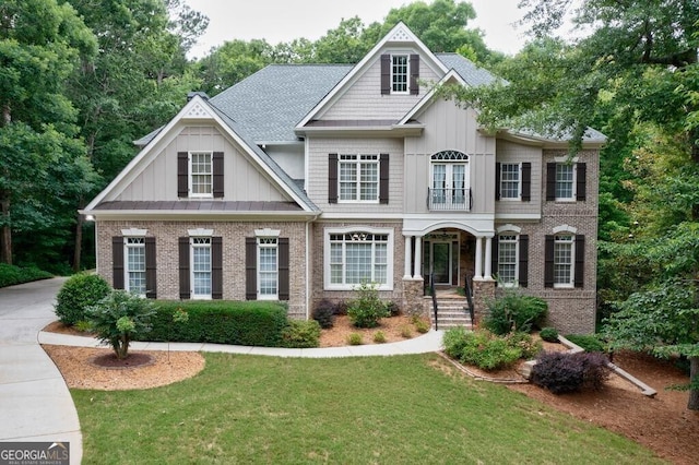 view of front of property with brick siding, board and batten siding, and a front lawn