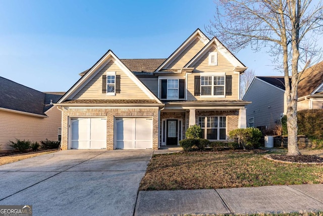 view of front facade featuring brick siding, driveway, and a garage