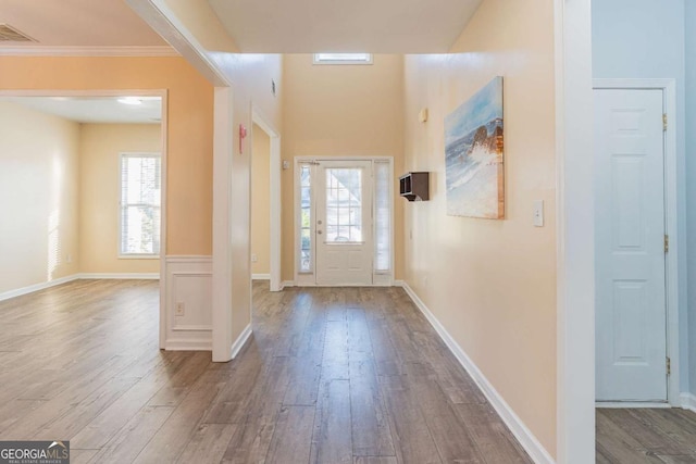 entryway with wood finished floors, visible vents, and baseboards