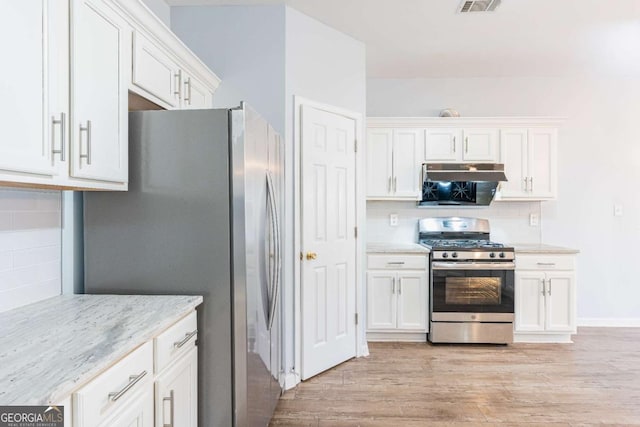 kitchen featuring stainless steel appliances, decorative backsplash, white cabinets, under cabinet range hood, and light wood-type flooring