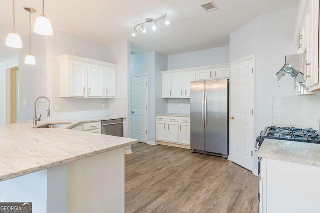 kitchen featuring visible vents, light wood-type flooring, a sink, white cabinetry, and appliances with stainless steel finishes