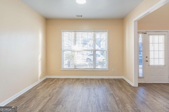 entrance foyer with visible vents, baseboards, and wood finished floors