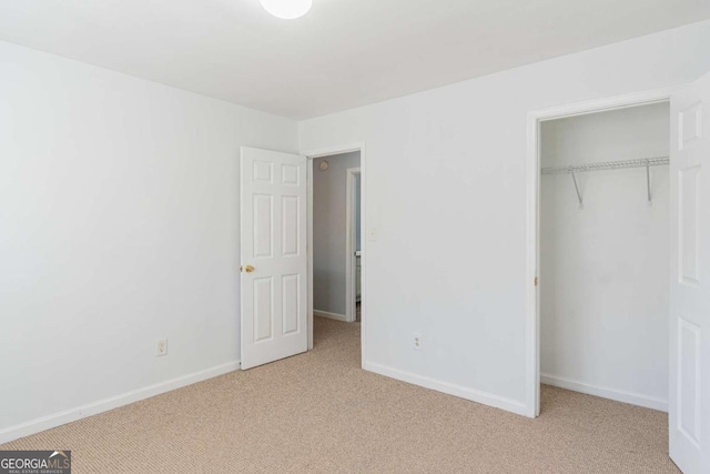 unfurnished bedroom with carpet flooring and baseboards