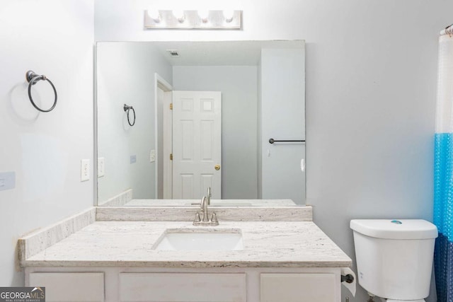 full bath featuring visible vents, toilet, and vanity