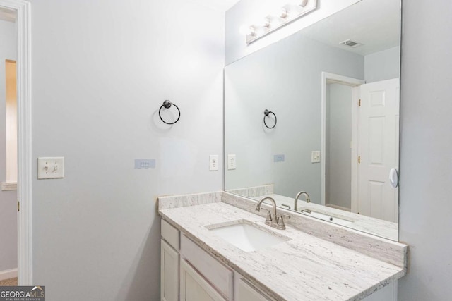 bathroom with vanity and visible vents