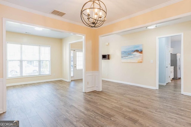 interior space with visible vents, wood finished floors, and crown molding