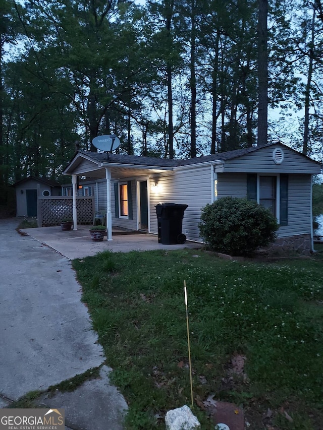 view of front facade with an outbuilding and a front yard