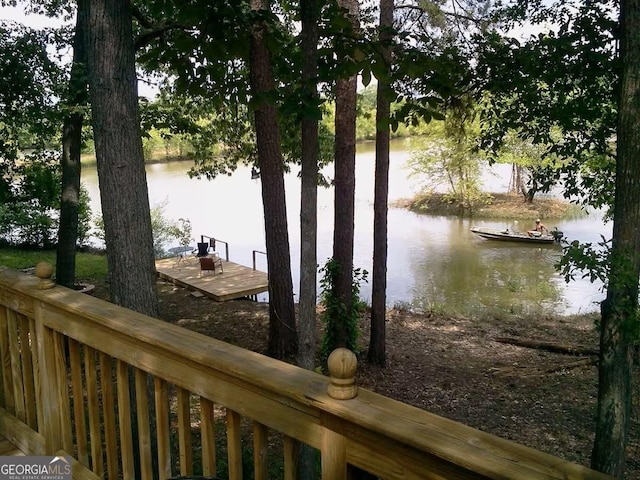 exterior space featuring a boat dock and fence