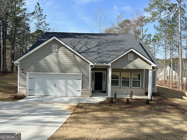 view of front of home with brick siding, an attached garage, driveway, and roof with shingles