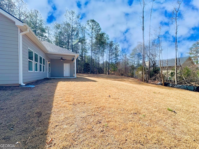 view of yard featuring a ceiling fan