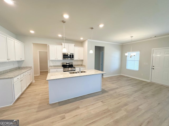 kitchen with backsplash, light wood-style flooring, stainless steel appliances, and a sink