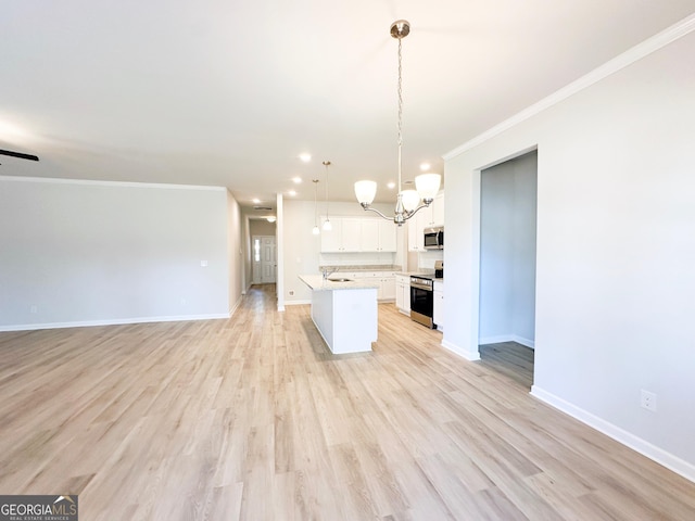 kitchen featuring open floor plan, stainless steel appliances, light countertops, and ornamental molding