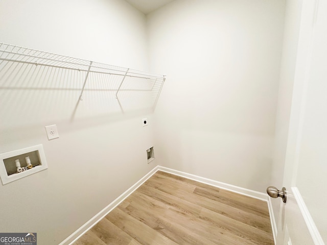 laundry area featuring hookup for a washing machine, baseboards, light wood finished floors, hookup for an electric dryer, and laundry area