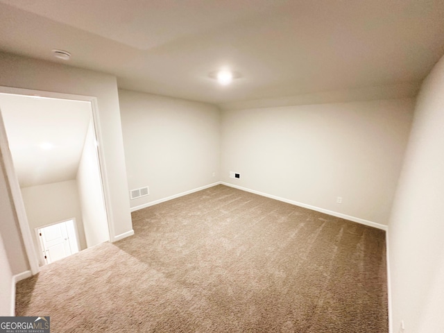 basement with carpet flooring, baseboards, and visible vents