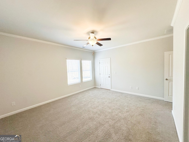 unfurnished room featuring a ceiling fan, carpet, baseboards, and ornamental molding