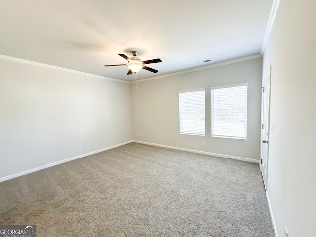 carpeted spare room with a ceiling fan, baseboards, visible vents, and ornamental molding