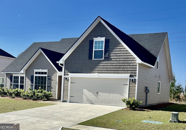 traditional-style house featuring a garage, concrete driveway, and a front lawn