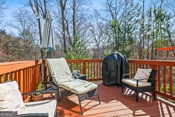 wooden deck featuring area for grilling