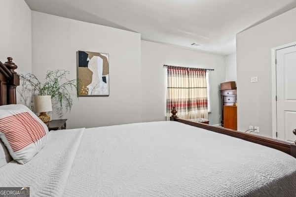 bedroom featuring visible vents