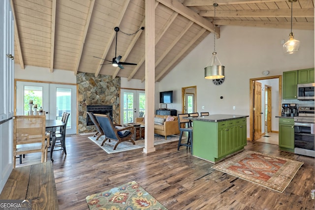 kitchen featuring green cabinets, dark countertops, french doors, and appliances with stainless steel finishes