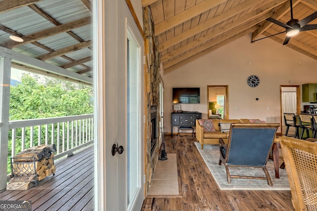 living area featuring visible vents, high vaulted ceiling, beam ceiling, hardwood / wood-style flooring, and wood ceiling