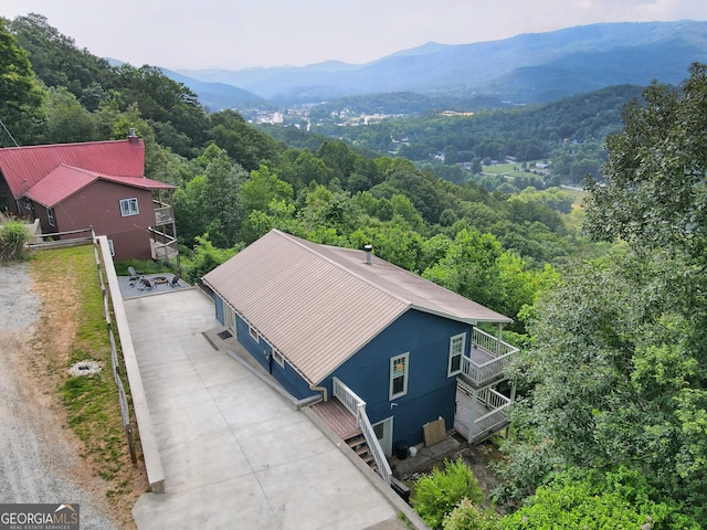 bird's eye view featuring a forest view and a mountain view