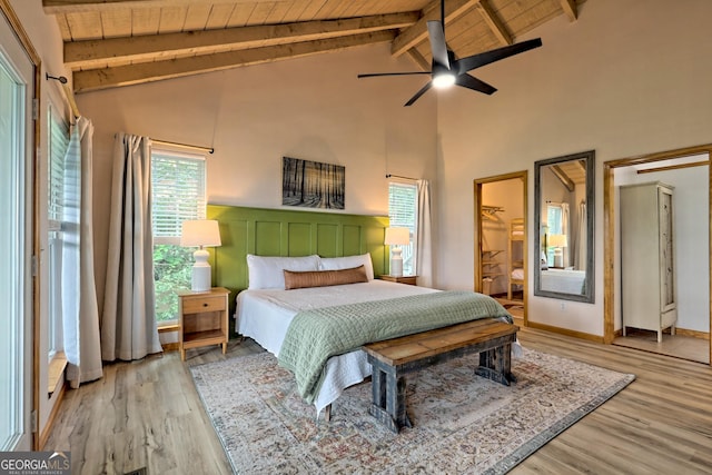 bedroom with beamed ceiling, wood finished floors, and wooden ceiling