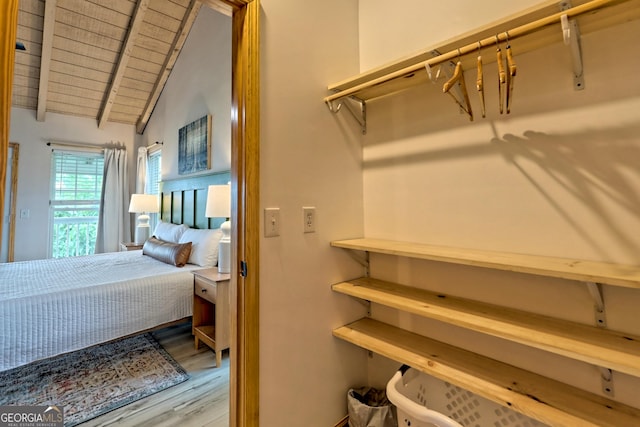 bedroom with wood finished floors, wooden ceiling, and vaulted ceiling with beams