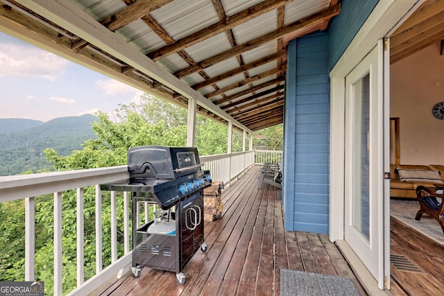 wooden terrace featuring a mountain view and grilling area