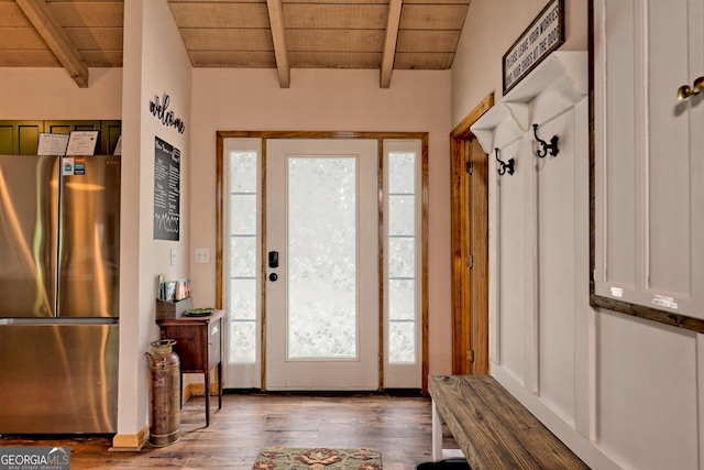 foyer featuring beam ceiling, wood ceiling, and wood finished floors