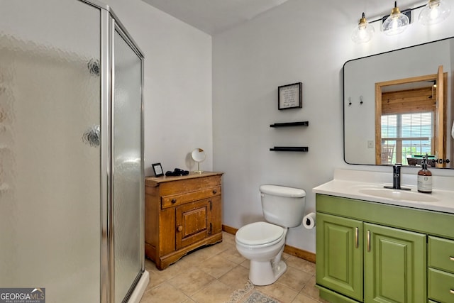 bathroom with a shower stall, baseboards, toilet, tile patterned floors, and vanity