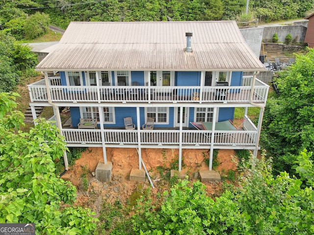 view of front facade with metal roof and a patio