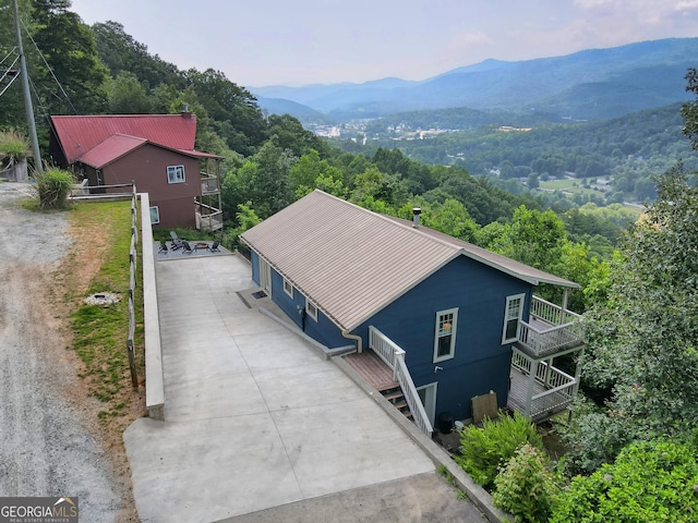 aerial view with a wooded view and a mountain view