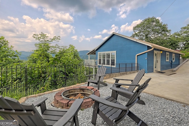 view of patio featuring a fire pit and fence