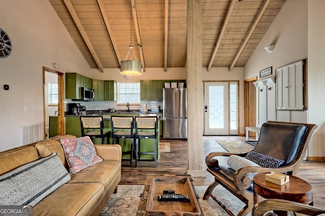 living room with visible vents, beam ceiling, wood ceiling, and wood finished floors