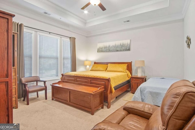 bedroom featuring visible vents, a raised ceiling, light carpet, and ornamental molding