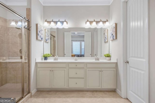 full bathroom featuring a sink, a stall shower, and ornamental molding