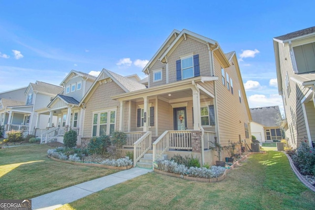 craftsman-style house featuring covered porch and a front lawn