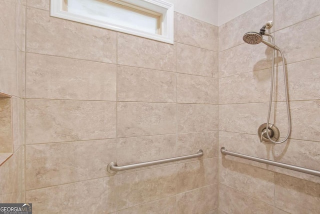 bathroom with tiled shower