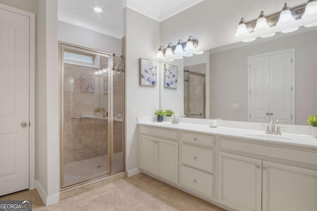 full bath featuring a sink, double vanity, a stall shower, and crown molding